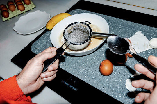 Sifting flour and preparing homemade birthday cake in kitchen