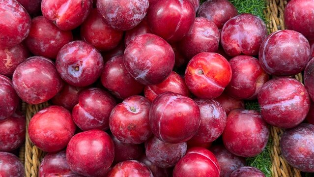 red plum on the basket in supermarket