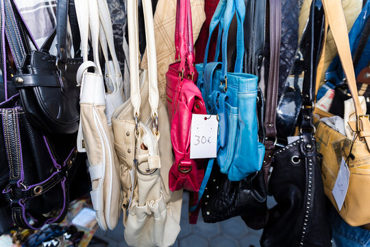 Colorful handbags with price tag displayed at flea market stall