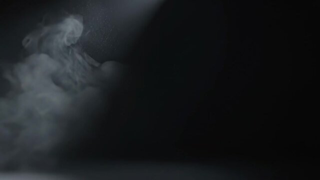 Dark Studio Haze \'96 Subtle drifting cinematic atmosphere, deep charcoal studio space filled with barely visible layers of soft gray haze, gentle side lighting creating faint volumetric shafts