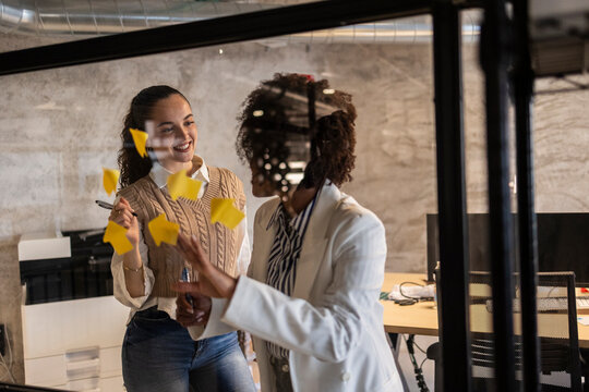 Professional teamwork brainstorming with sticky notes in modern office