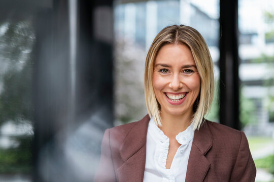 Portrait of happy young businesswoman in the city