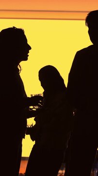 People silhouette in gold shine - conversation and communication - unrecognizable people - conference