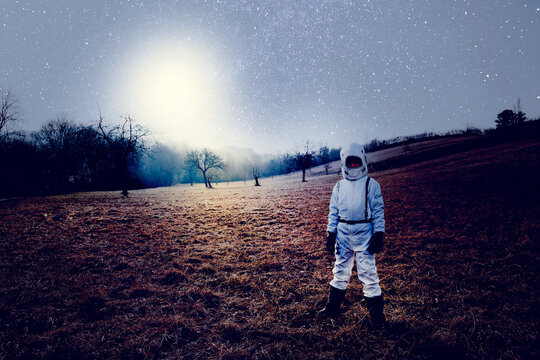 Boy wearing white space suit, starry sky