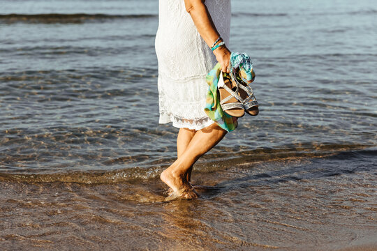 Close-up of senior woman wading in the sea, El Roc de Sant Gaieta, Spain