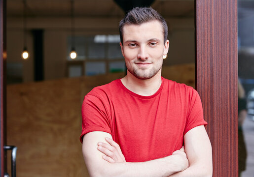 Portrait of a young man with crossed arms