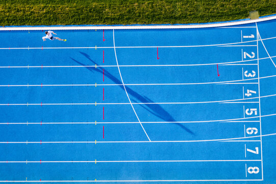 Top view of runner on blue tartan track