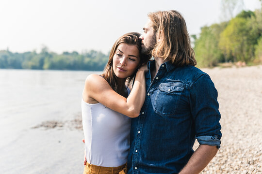 Young couple in love at the riverside