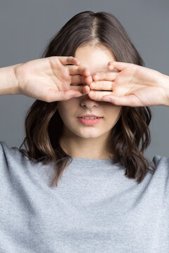 Portrait of brunette young woman, see no evil