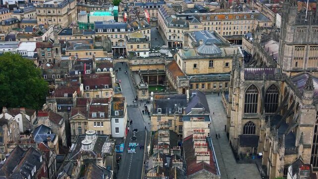 Aerial drone view of the historic Roman Baths complex beside Bath Abbey in the city of Bath Somerset England