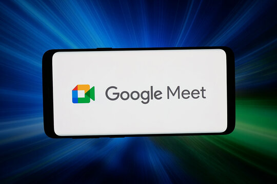 Stuttgart, Germany - 03-02-2026: In this photo illustration, the logo of video communication platform Google Meet is displayed on a smartphone in front of abstract background on computer screen.