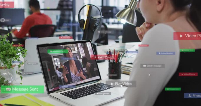 Woman watching laptop in office with playback starting, UI badges appearing confirming messages