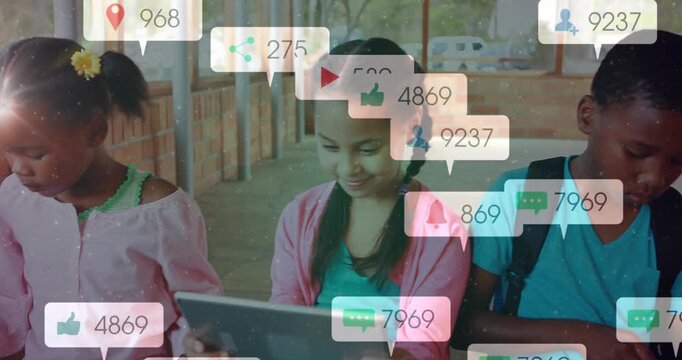 Children tapping tablets and causing social alerts while doing digital learning in classroom