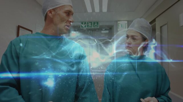 Two surgeons opening file and planning surgery in corridor, holo ribbon showing faces between them