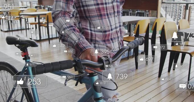 Man guiding teal bicycle while shifting grip, causing animated alert icons updating for marketing