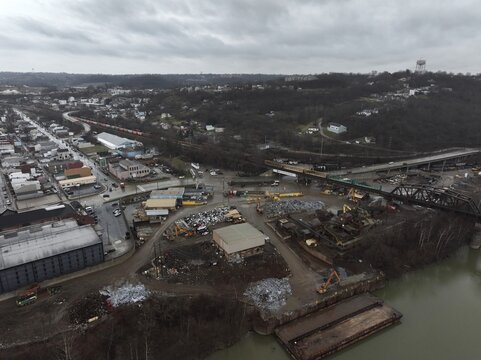 Aerial view of the industrial area along the riverbank, where bridges connect the city amidst the overcast sky, Newport, Kentucky, United States.