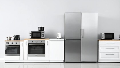 Fototapeta premium A modern kitchen with built-in appliances and white cabinetry against a neutral wall