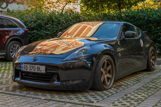 Tbilisi, Georgia, 10.29.2025 Black Nissan 370Z Parked Near Residential Buildings