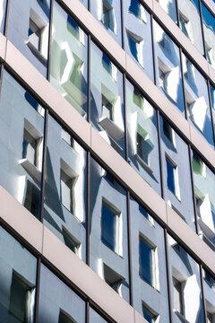 Corporate modern architecture office building exterior with windows and a facade grid pattern creating structured urban geometry for business background