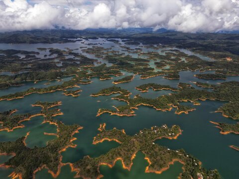 Aerial view of a maze of islands creating a stunning tapestry of emerald waters and earth tones, Guatape, Antioquia, Colombia.