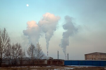 Smoking chimneys of a combined heat and power plant. Coal burning, fossil fuel use. Ecology,...