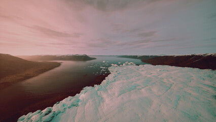 Aerial view river foam at dusk, pastel sky over tranquil estuary and coastline, drifting ice floes on gentle tidal current, soft pink and teal light bathing © icetray