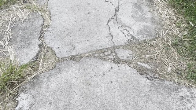 The damaged walkway shows deep cracks and structural damage