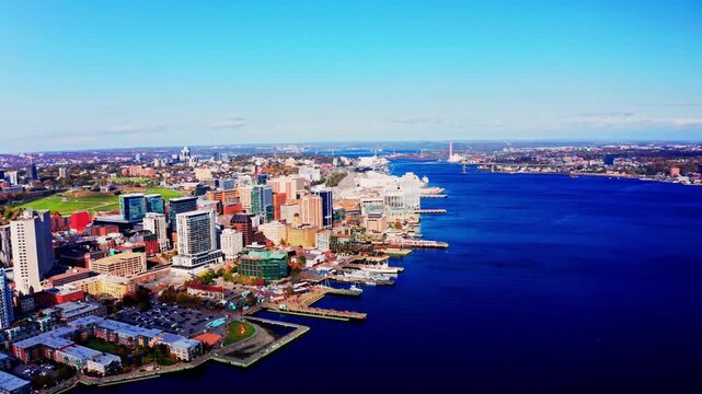 Aerial drone view of downtown Halifax skyline and Atlantic harbor in Nova Scotia, Canada &ndash; 07 July 2026 &ndash; modern urban buildings and ocean waterfront under clear summer sky cinematic 4K.