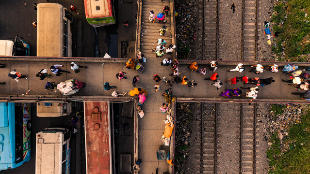 Lagos, Nigeria - 24 February 2026: Aerial view of the Oshodi pedestrian overpass bustling with vibrant life above the stark railway tracks.