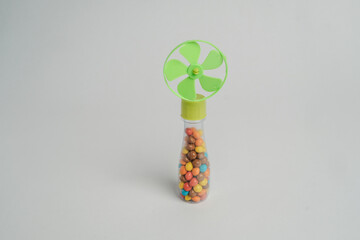 Fototapeta premium Colorful Candy Filled Handheld Mini Fan Isolated