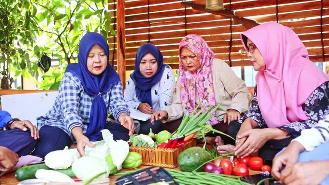 Muslim indonesian women preparing fresh vegetables for cooking class