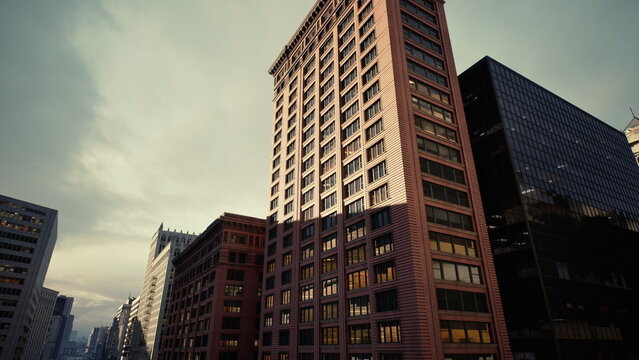 dusk city street towering brick buildings with warm sunlight on facades, glass reflections and dramatic clouds, upward camera pan revealing historic masonry