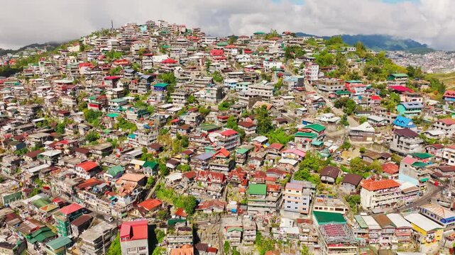 Drone flying backward showing colorful hillside community in Quirino Hill
