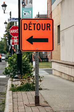Drummondville, Canada - August 24, 2025: Orange detour road sign with left arrow during street works in Drummondville, Quebec