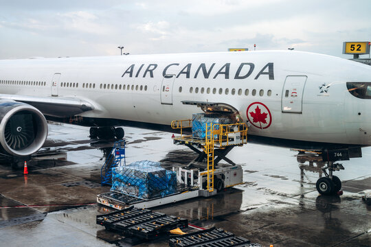 Montreal, Canada - August 24, 2025: Air Canada aircraft being loaded with cargo at the gate at Montreal Trudeau International Airport