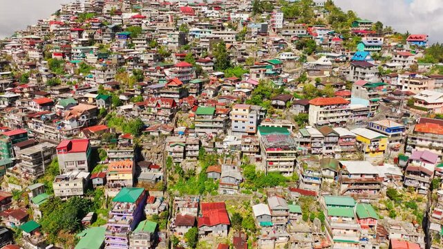 Drone flying higher over colorful hillside community in Lower Quirino Hill