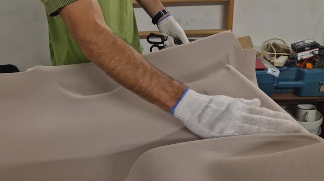 Car headliner upholstery repair man working on automotive interior in workshop