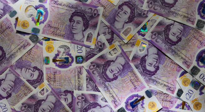 Spread 20 GBP Notes Scattered on Wooden Table