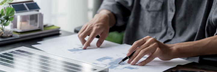 Business man generates renewable energy innovations in eco office workspace