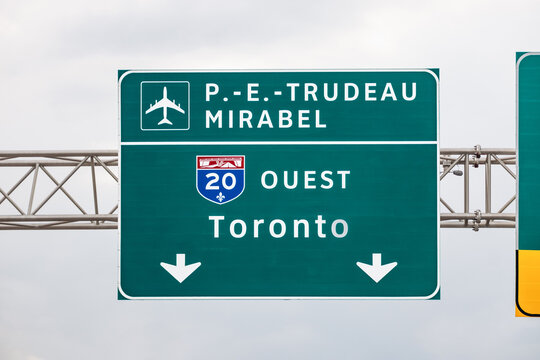 Montreal, Canada - August 24, 2025: Highway sign for Autoroute 20 West toward Toronto and Pierre Elliott Trudeau and Mirabel airports near Montreal