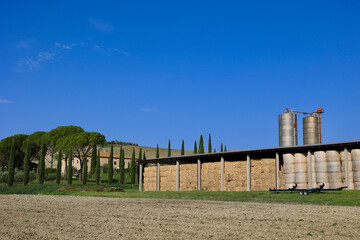 Naklejka premium Hay Storage Barn and Farm Silos in the Tuscan Countryside near Pienza, Italy