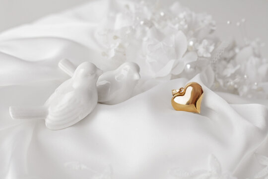 golden jewellery heart on bridal white dress