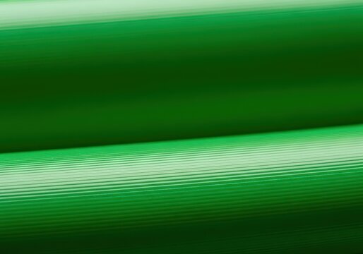 Close-up view of industrial green polyvinyl chloride material, showing flexible plastic texture. Abstract background for design work, background, smooth, bright