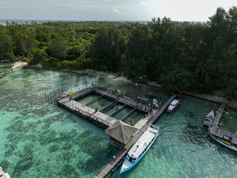 Aerial view of the Shark Breeding Menjangan Kecil, where turquoise waters meet the dark timbers of the breeding pens, Karimunjawa, Central Java, Indonesia.