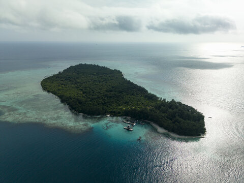 Aerial view of the lush green island surrounded by the turquoise sea, Shark Breeding Menjangan Kecil, Karimunjawa, Central Java, Indonesia.