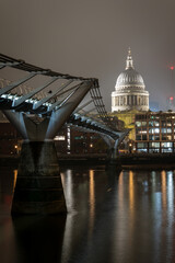 Fototapeta premium St Pauls Cathedral illuminated at night viewed from Millennium Bridge London