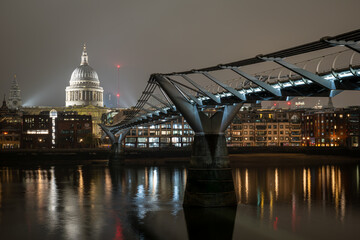 St Pauls Cathedral illuminated at night viewed from Millennium Bridge London