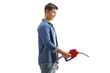 Young man holding a refueling nozzle