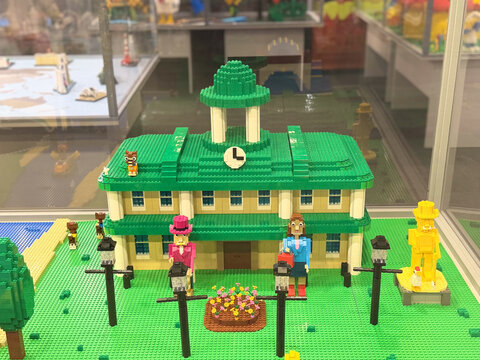 Green-roofed lego building with clock tower