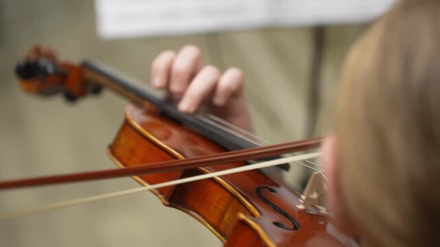 The Girl plays and trains the violin at a music school. A child's violin lesson. High quality video